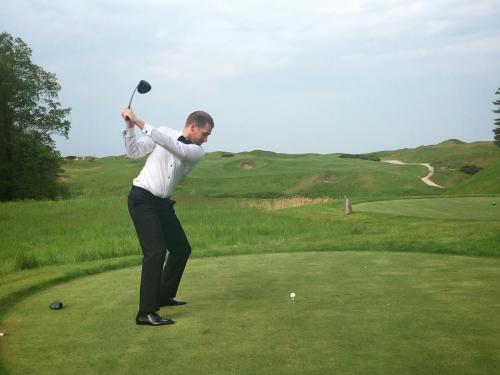 Dr Thomas Oliver teeing off on his wedding day